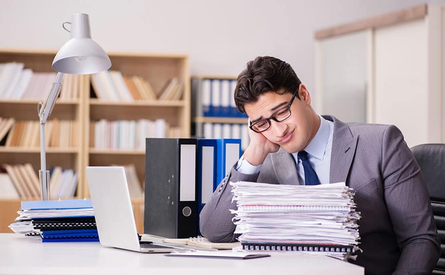 Businessman looking at a stack of client feedback reports.