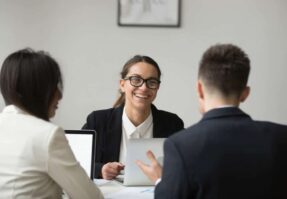 Smiling businesswoman talking with colleagues about CX reports